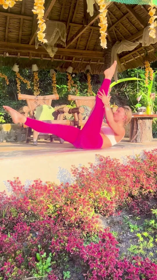 A gentle yoga movement on the villa terrace, surrounded by a tropical garden